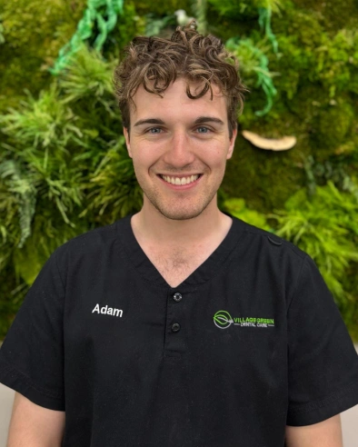 Adam, Insurance Coordinator at dental practice in Kanata, smiling at camera.