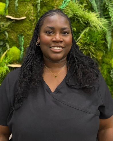 Dora Lubangi, Certified Dental Assistant at Kanata dental practice, smiling at camera.