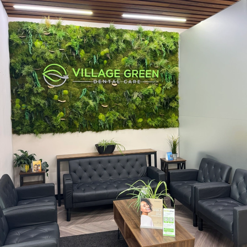 Village Green Dental Care reception area with modern seating and living green wall.