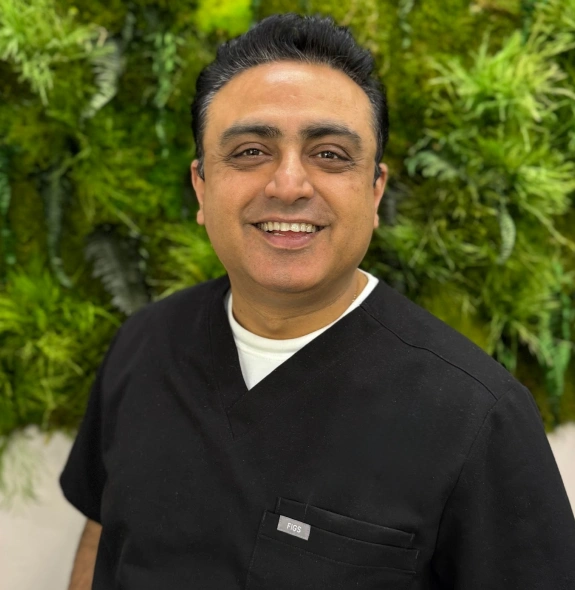 Dr. Vijayant Kapur smiles at his Kanata dental practice.