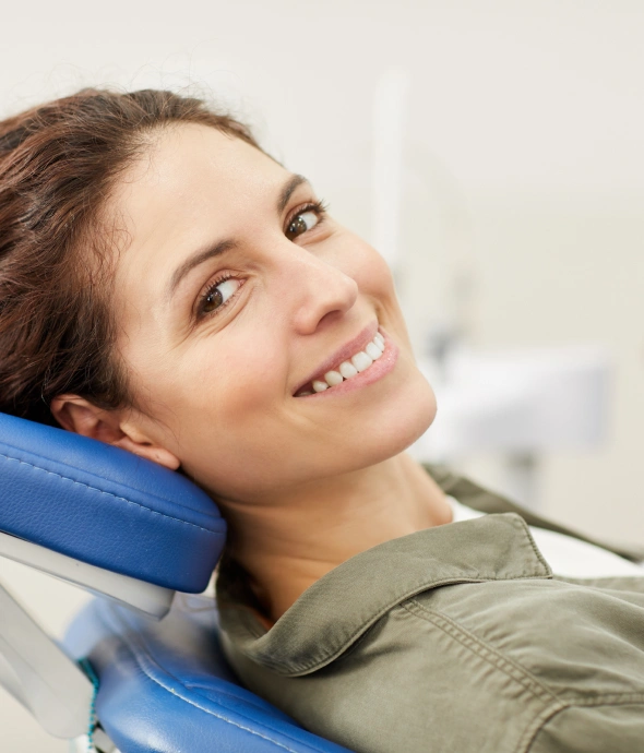 Smiling patient relaxing in dental chair during sedation dentistry treatment at Kanata clinic.