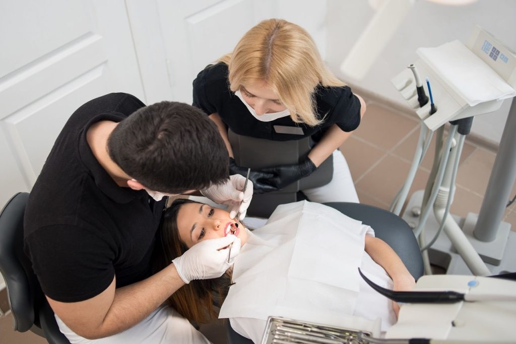 Emergency dentists performing surgery on patient