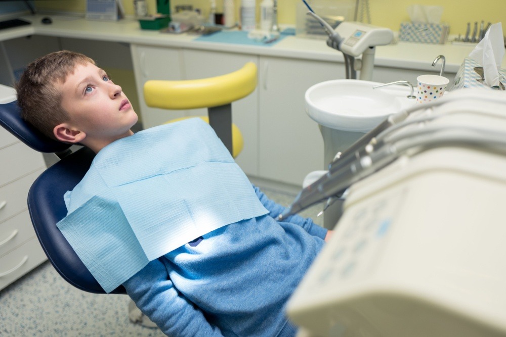 a young boy anxious at the dentist