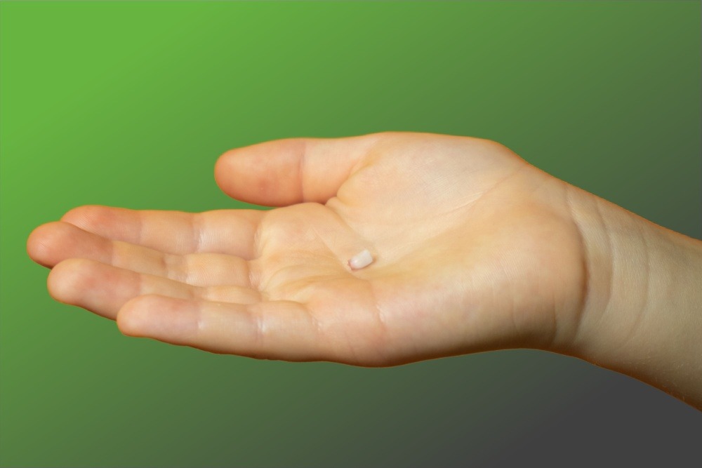 Person holding a knocked out tooth